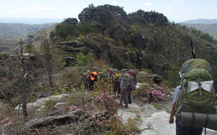 a group of people wearing backpacks hike along a trail in the blue ridge mountains 